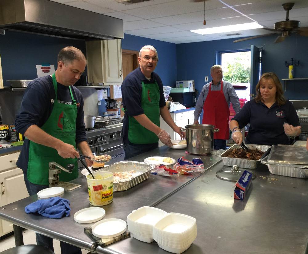 Mike Immler and volunteers preparing a meal for neighbors