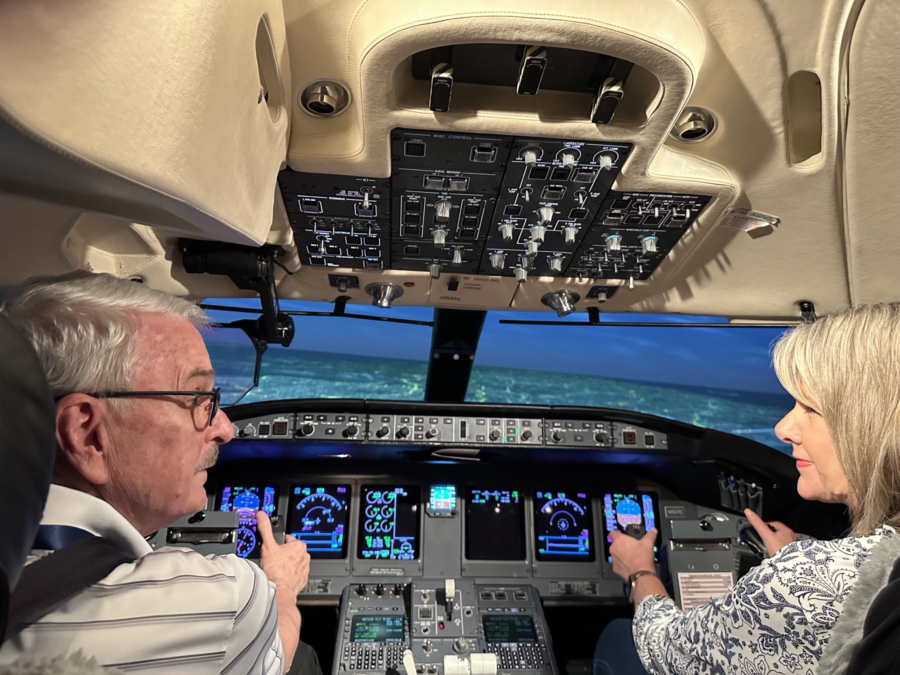 Mike Immler and his wife exploring a flight simulator